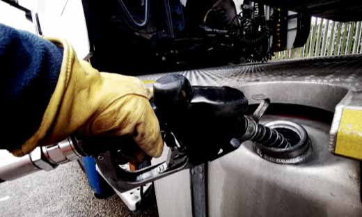 Driver Pumping Gas Into Semi-Truck